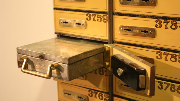 Image of an open safe deposit box.